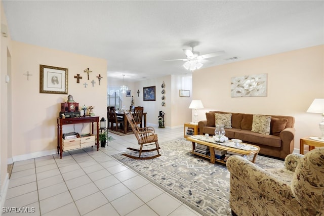 tiled living room featuring ceiling fan and a healthy amount of sunlight