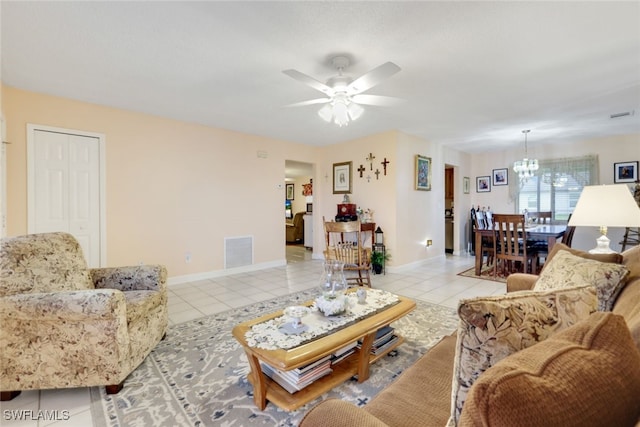 living room with light tile patterned flooring and ceiling fan with notable chandelier