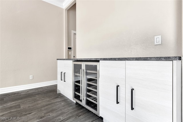 details with wood-type flooring, crown molding, and wine cooler