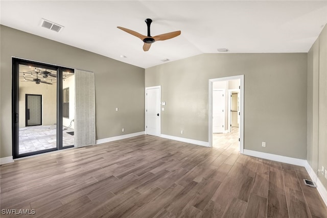 unfurnished bedroom featuring ceiling fan, wood-type flooring, access to outside, and vaulted ceiling