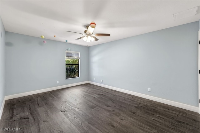 empty room with ceiling fan and dark wood-type flooring