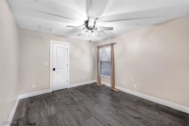 empty room featuring ceiling fan and dark hardwood / wood-style floors