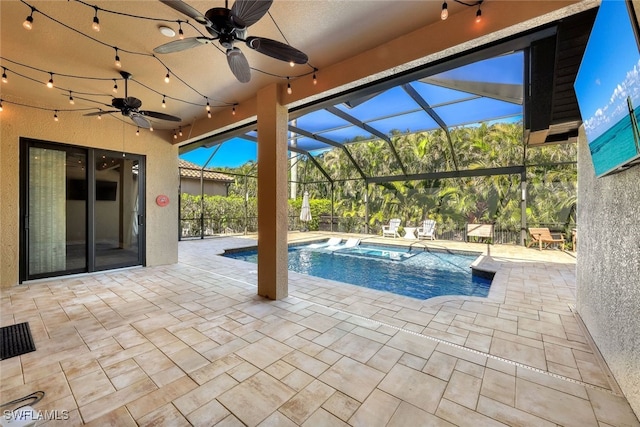 view of pool with a patio, ceiling fan, and a lanai