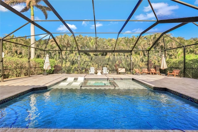 view of swimming pool featuring glass enclosure, an in ground hot tub, and a patio