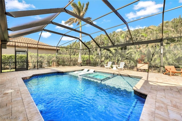 view of swimming pool featuring an in ground hot tub, a patio, and a lanai