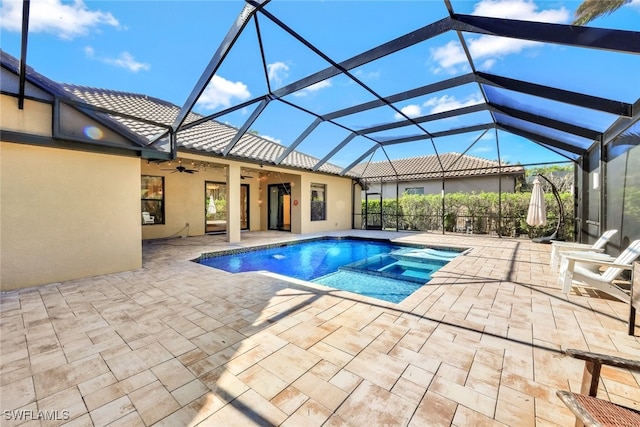 view of swimming pool with a lanai, a patio area, and ceiling fan