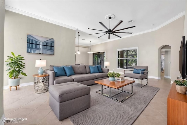 tiled living room featuring ceiling fan and crown molding