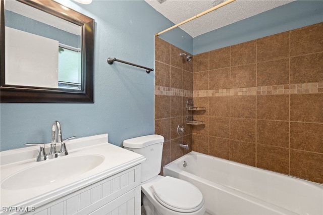 full bathroom featuring vanity, toilet, a textured ceiling, and tiled shower / bath