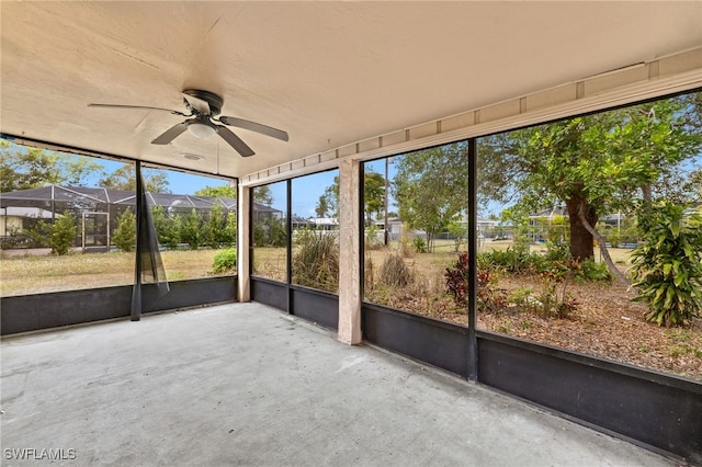 unfurnished sunroom featuring ceiling fan