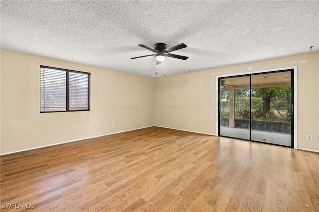 spare room featuring ceiling fan, light hardwood / wood-style floors, and a textured ceiling