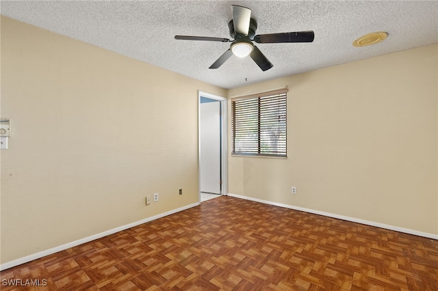 spare room with a textured ceiling, parquet floors, and ceiling fan