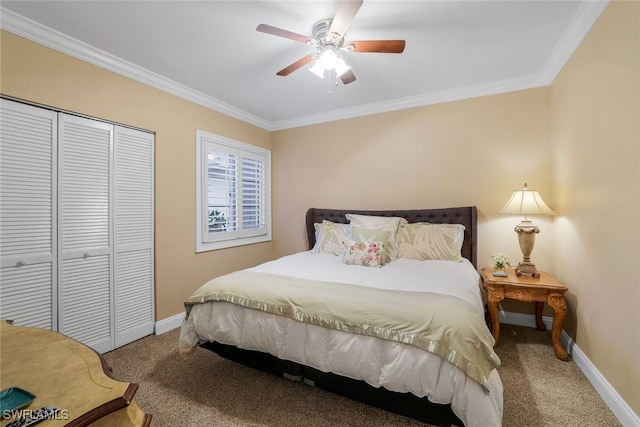 carpeted bedroom with a closet, ceiling fan, and crown molding