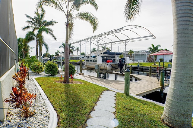 view of dock featuring glass enclosure, a water view, and a yard