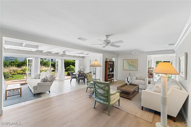 living room featuring beam ceiling, light hardwood / wood-style flooring, ceiling fan, and ornamental molding