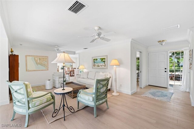 living room featuring ceiling fan, light hardwood / wood-style floors, and ornamental molding