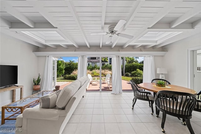 tiled living room with ceiling fan, beam ceiling, and a wealth of natural light