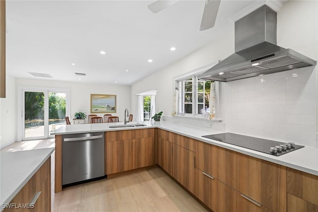 kitchen with dishwasher, wall chimney exhaust hood, plenty of natural light, and sink