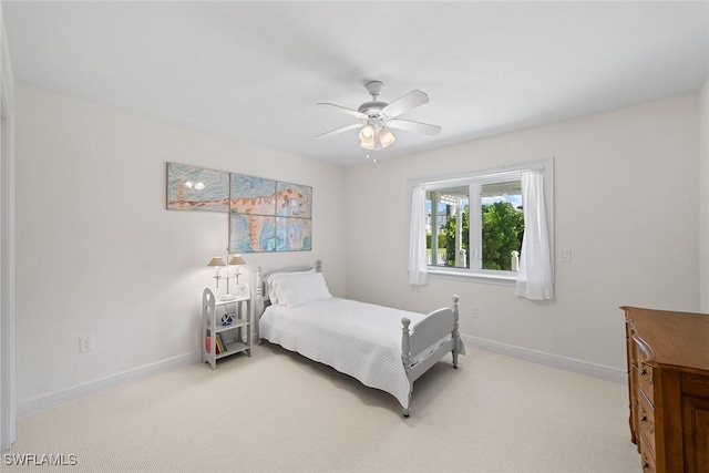 bedroom with ceiling fan and light carpet