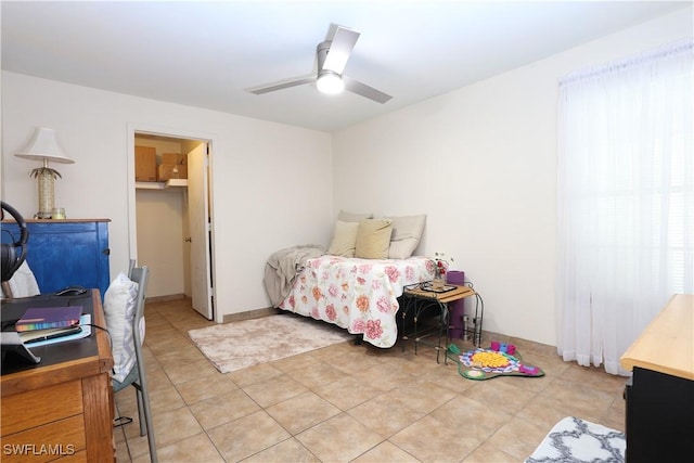 bedroom with light tile patterned floors and ceiling fan