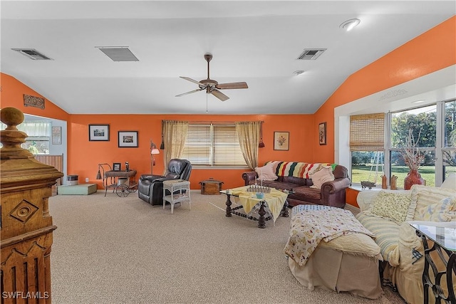 living room with carpet flooring, a healthy amount of sunlight, and vaulted ceiling