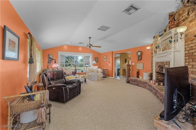 living room featuring ceiling fan, a fireplace, carpet, and lofted ceiling