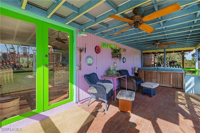 view of patio / terrace with ceiling fan, french doors, and a hot tub