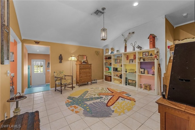 sitting room with tile patterned floors, lofted ceiling, and crown molding