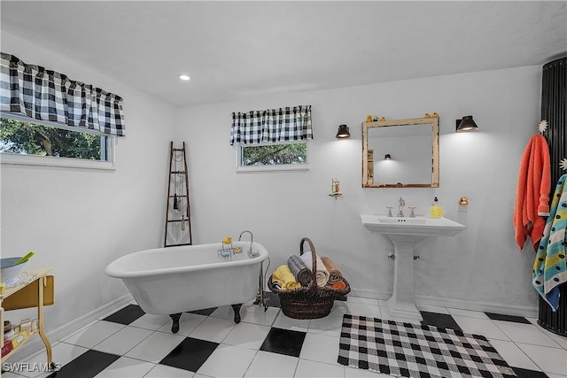 bathroom with tile patterned floors and a tub