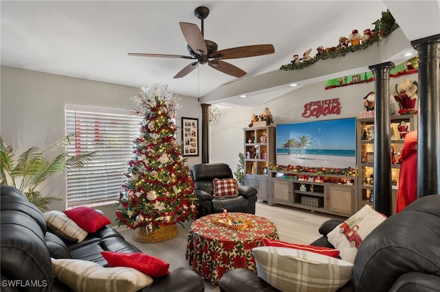 living room featuring ceiling fan, vaulted ceiling, ornate columns, and light hardwood / wood-style flooring