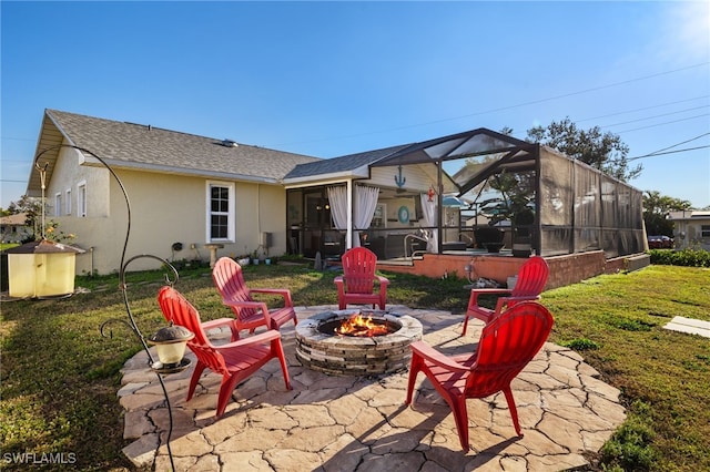 view of patio / terrace featuring glass enclosure and a fire pit