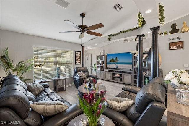 living room with decorative columns, lofted ceiling, ceiling fan, and light hardwood / wood-style flooring