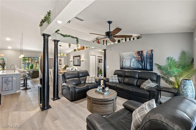 living room featuring vaulted ceiling, ceiling fan, light hardwood / wood-style floors, and ornate columns