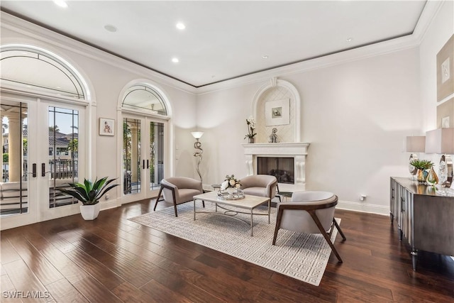 living area with french doors, dark hardwood / wood-style flooring, and crown molding