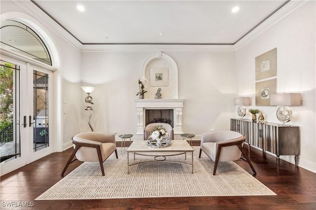 living area featuring french doors, ornamental molding, and hardwood / wood-style floors