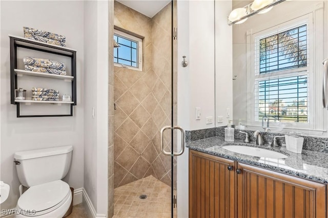 bathroom with a healthy amount of sunlight, a shower with shower door, and toilet