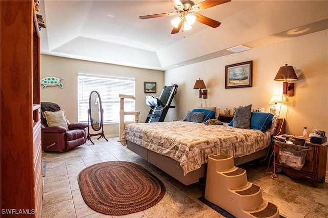 bedroom with ceiling fan and a raised ceiling