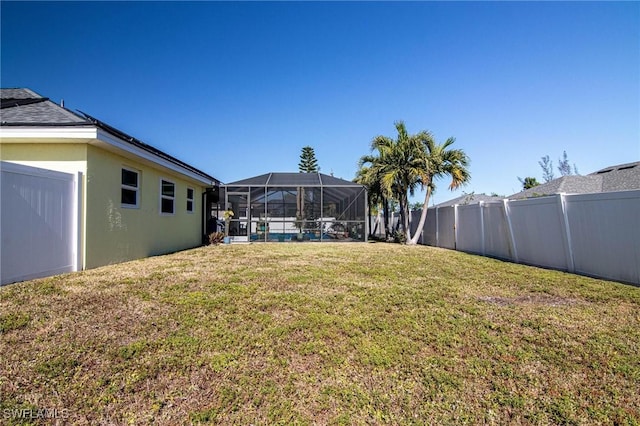 view of yard with a lanai and a swimming pool