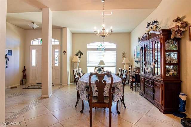 dining room with a notable chandelier and light tile patterned floors