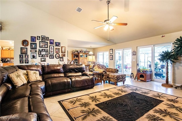 tiled living room featuring ceiling fan and high vaulted ceiling