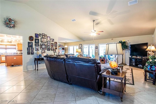 living room with ceiling fan, light tile patterned floors, and high vaulted ceiling