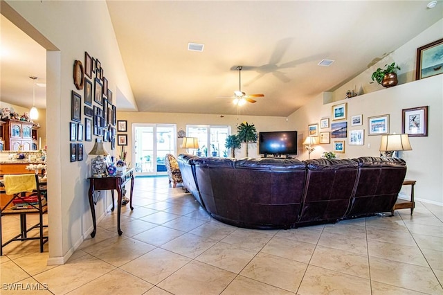 tiled living room with ceiling fan and high vaulted ceiling