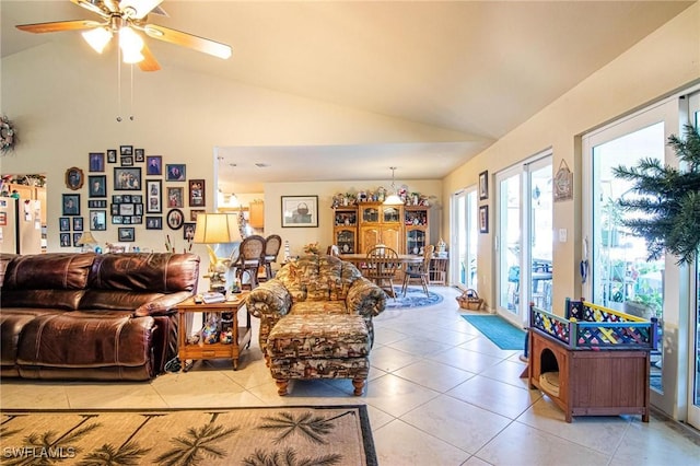 living room with ceiling fan, light tile patterned flooring, and vaulted ceiling