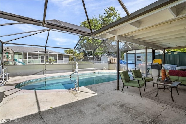 view of pool with glass enclosure, a shed, and a patio