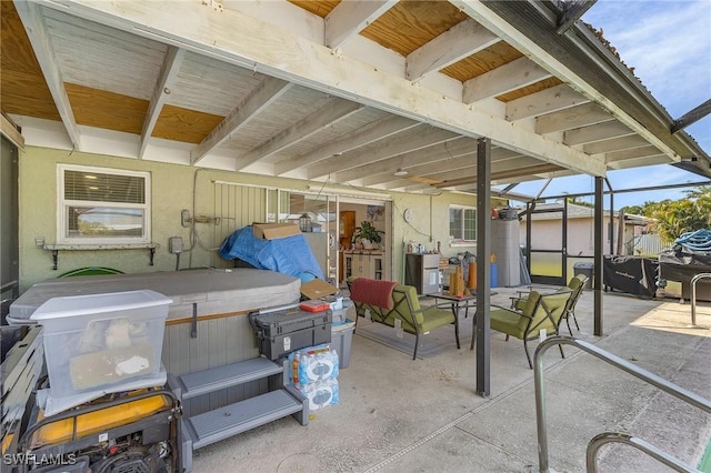 view of patio with a hot tub and a lanai