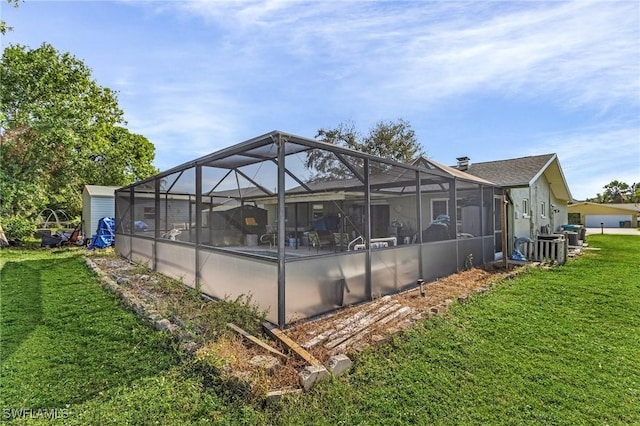 exterior space featuring a lanai and a lawn