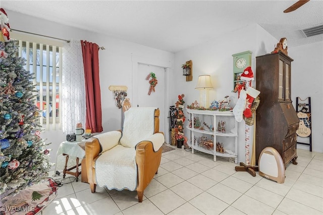 sitting room featuring ceiling fan and light tile patterned flooring