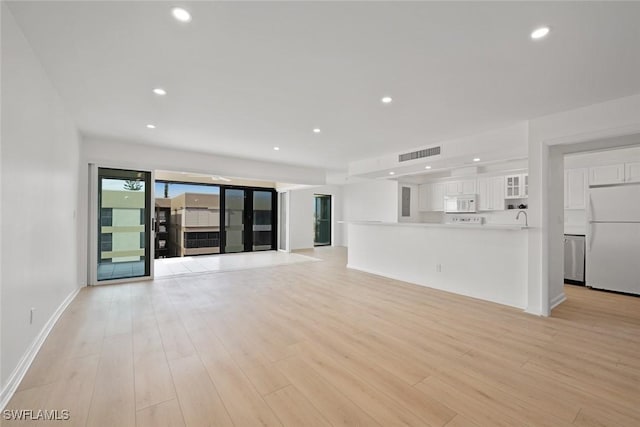 unfurnished living room featuring light hardwood / wood-style floors