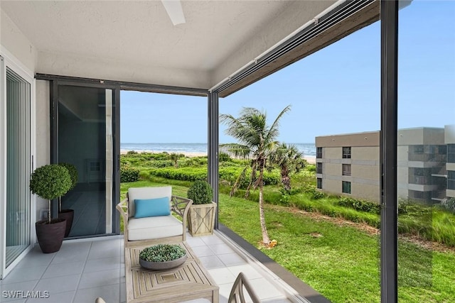 sunroom / solarium featuring a water view