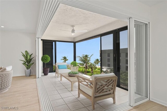 sunroom featuring ceiling fan