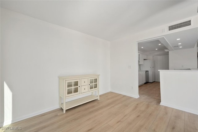 unfurnished room with light hardwood / wood-style flooring